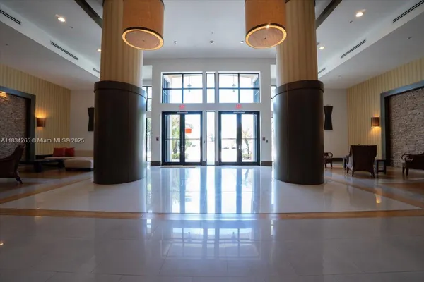 a lobby with furniture and floor to ceiling window