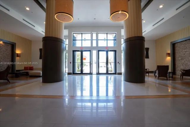 a lobby with furniture and floor to ceiling window