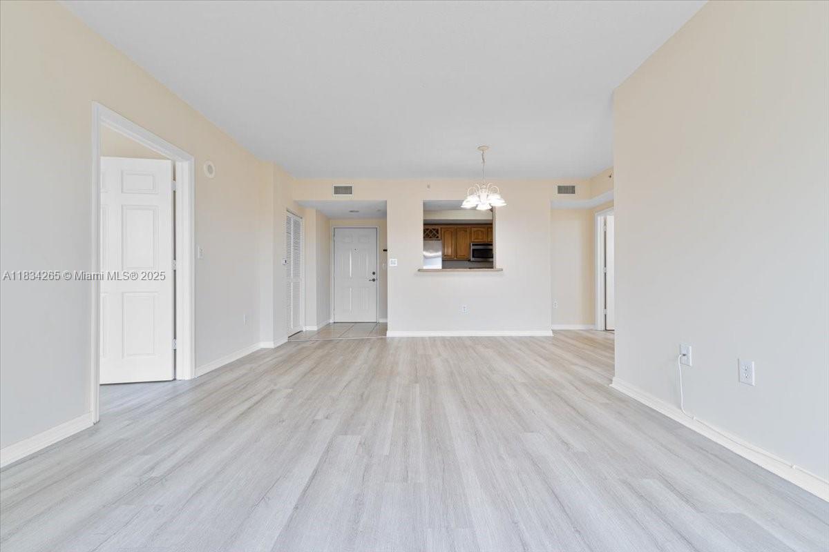 4242 Northwest 2nd Street, Unit 1601 Miami, FL 33126 - Photo 5 of 37 a view of a livingroom with wooden floor