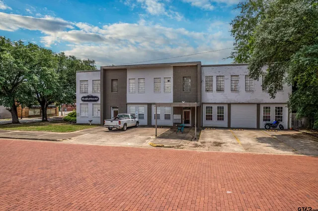 a view of a house with snow on the side of the road