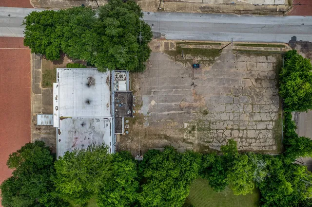 a aerial view of a house with a tree