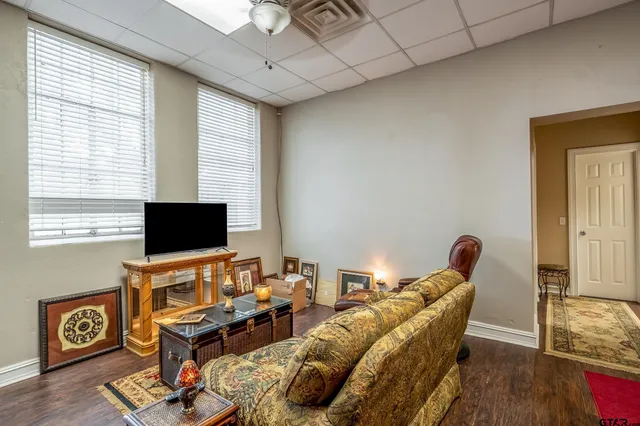 a view of a workspace with furniture and a window