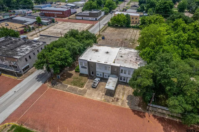 an aerial view of a house with a yard basket ball court and outdoor seating