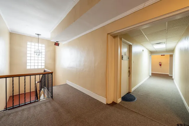 a view of hallway with windows