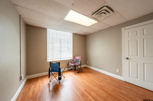 a living room with hardwood floor and a window