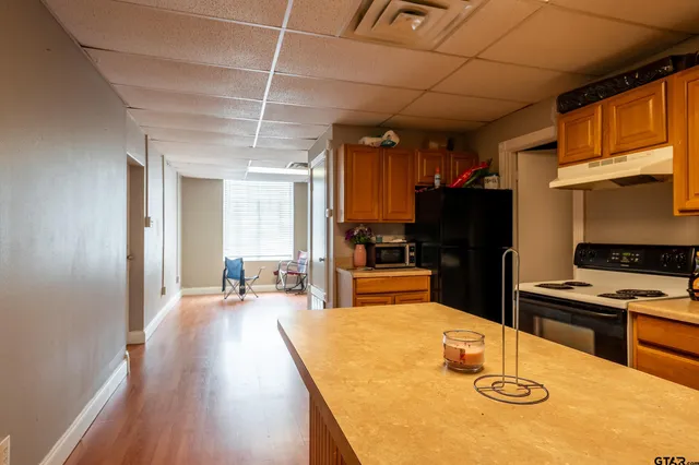 a kitchen with sink refrigerator and cabinets