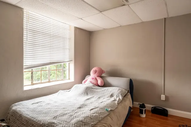 a bedroom with a bed and a window