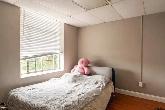 a bedroom with a bed and window