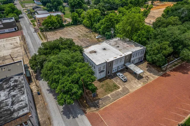 an aerial view of a house with garden space and sitting area