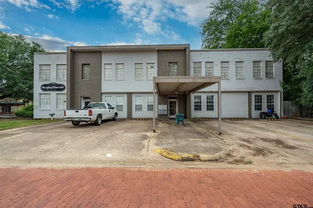 a view of a house with car parked