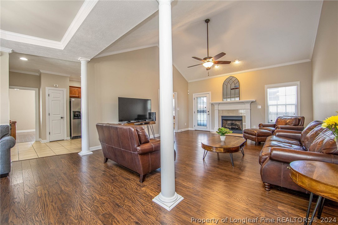 3304 Geyser Peak Road Fayetteville, NC 28306 - Photo 12 of 39 a living room with furniture a fireplace and a flat screen tv