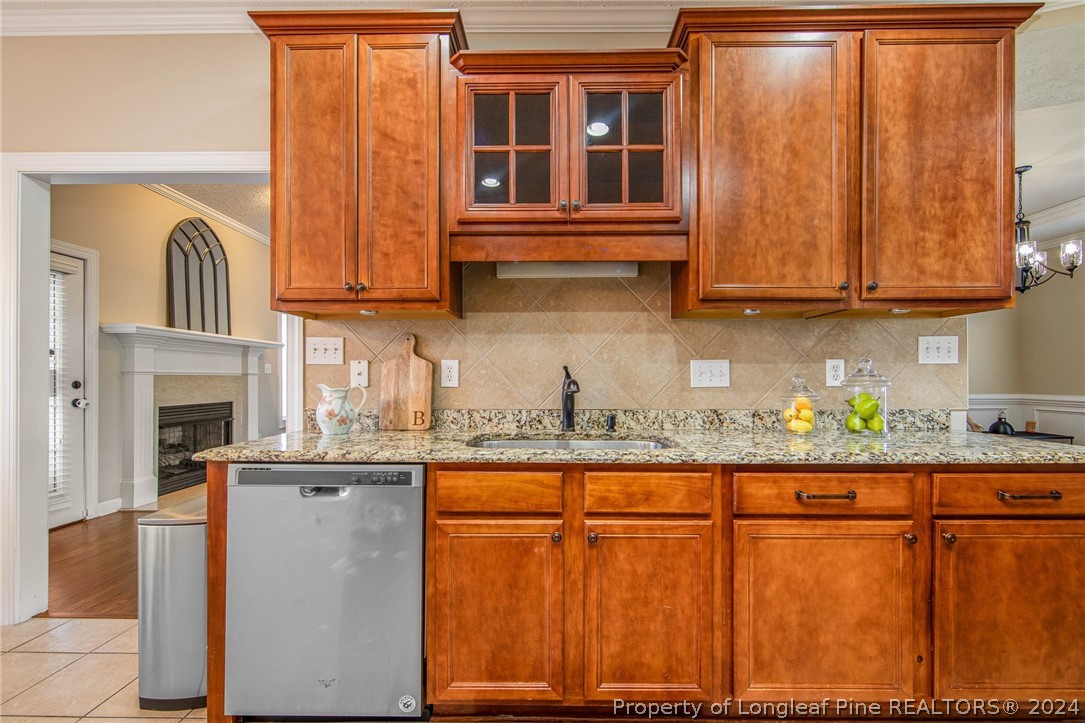 3304 Geyser Peak Road Fayetteville, NC 28306 - Photo 14 of 39 a kitchen with stainless steel appliances granite countertop a granite counter tops and a wooden cabinets