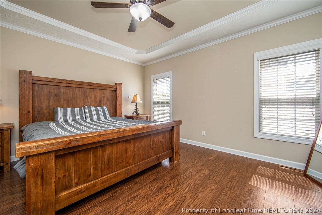 3304 Geyser Peak Road Fayetteville, NC 28306 - Photo 19 of 39 a view of a bedroom with wooden floor and fan