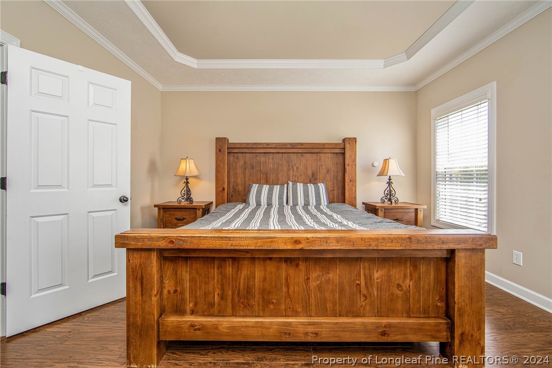 3304 Geyser Peak Road Fayetteville, NC 28306 - Photo 20 of 39 a bedroom with a bed and wooden floor