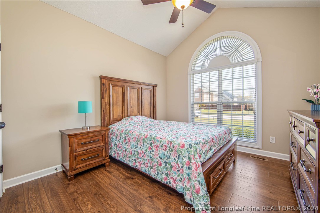 3304 Geyser Peak Road Fayetteville, NC 28306 - Photo 26 of 39 a bedroom with a bed a chandelier and a window