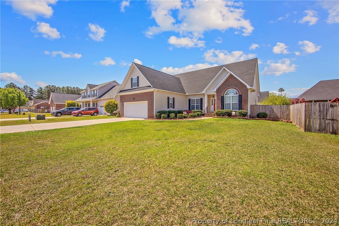 3304 Geyser Peak Road Fayetteville, NC 28306 - Photo 36 of 39 a front view of a house with a big yard