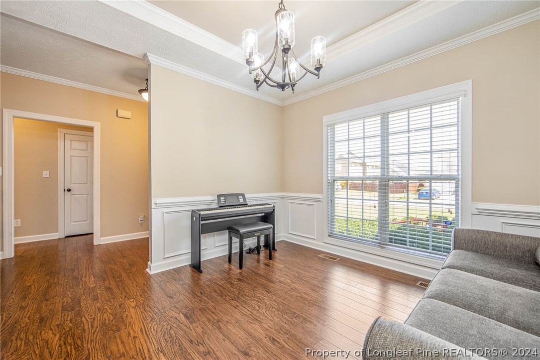 3304 Geyser Peak Road Fayetteville, NC 28306 - Photo 10 of 39 a living room with furniture and a wooden floor