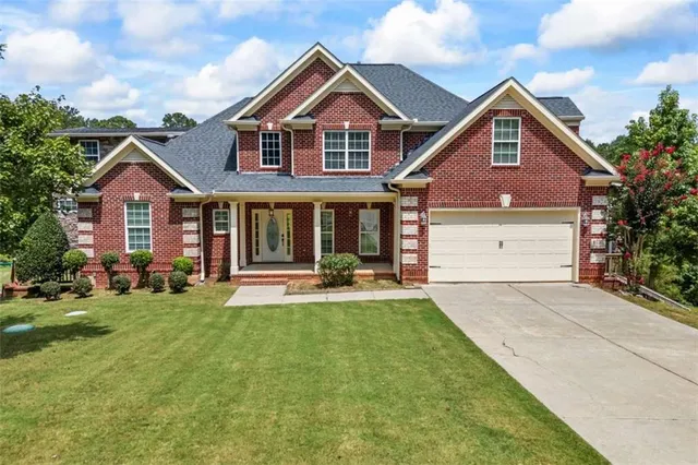 a front view of a house with a yard