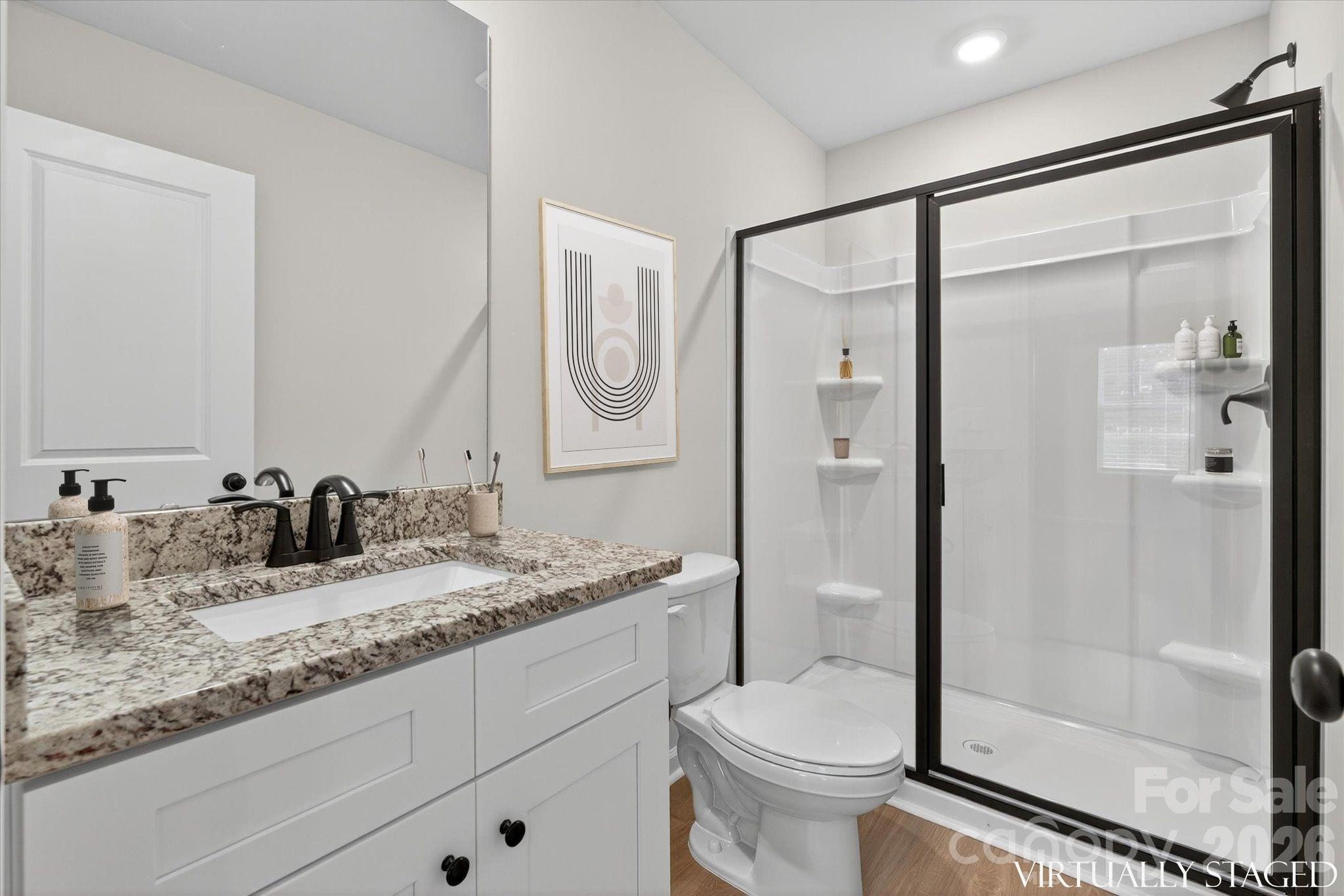 1219 Signal Street Gastonia, NC 28052 - Photo 13 of 16 a bathroom with a granite countertop sink toilet and shower