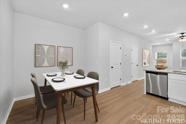 a view of a dining room with furniture and wooden floor