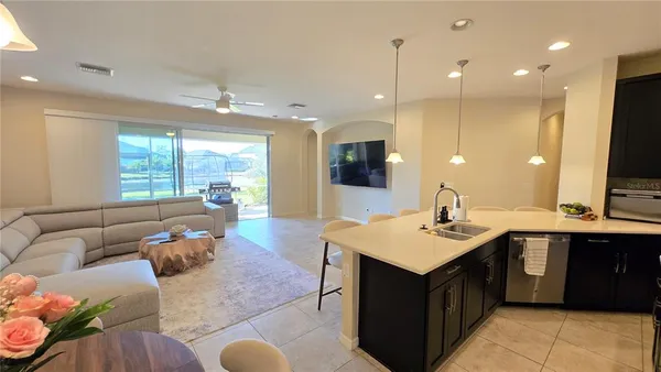 a kitchen with kitchen island granite countertop a sink counter top space and a sink