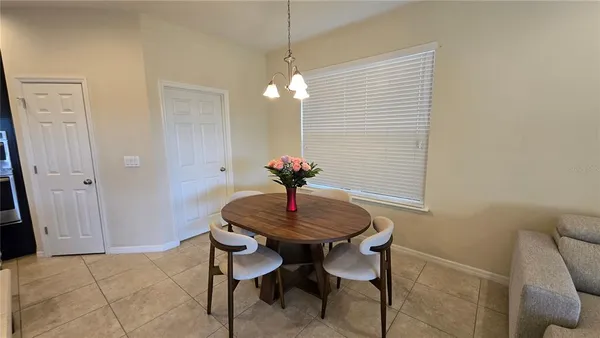 a dining room with furniture and wooden floor