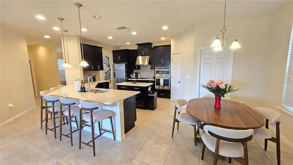 a kitchen with a table and chairs in it