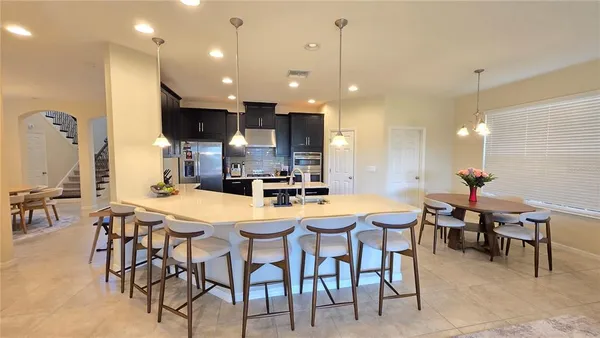 a large kitchen with a table and chairs