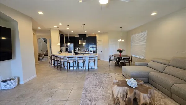 a living room with furniture and kitchen view