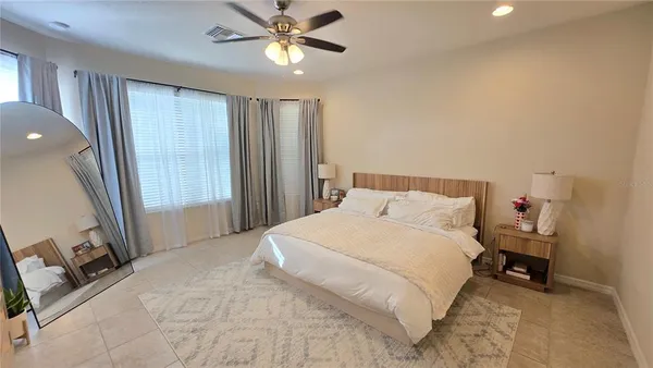 a bedroom with a bed and a large mirror