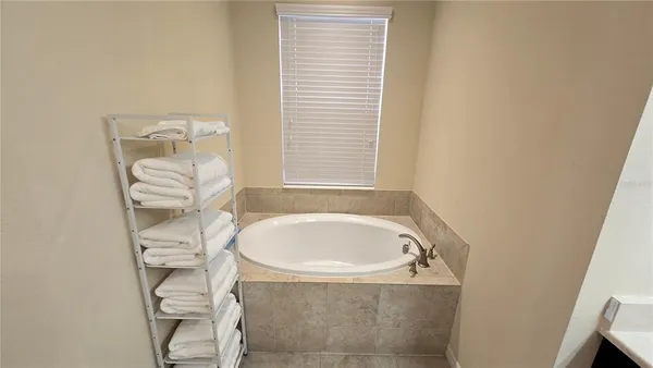 a bathroom with a bathtub and a window