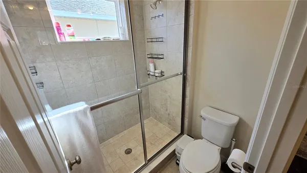 a bathroom with a toilet and a shower