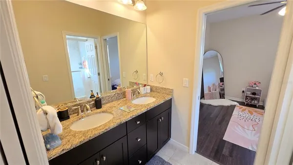 a bathroom with a double vanity sink and a mirror