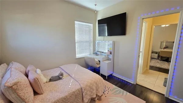 a bedroom with a bed and a flat screen tv