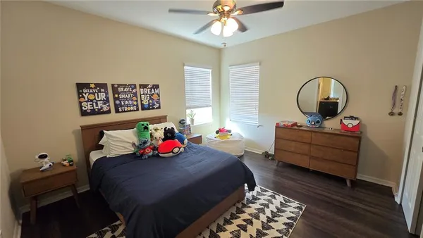a bedroom with furniture and a wooden floor