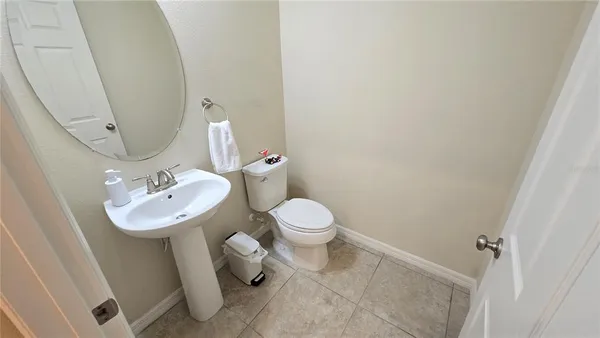 a bathroom with a granite countertop sink a toilet and a mirror