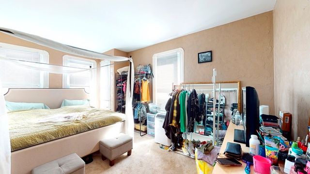 a bedroom with bed and a window