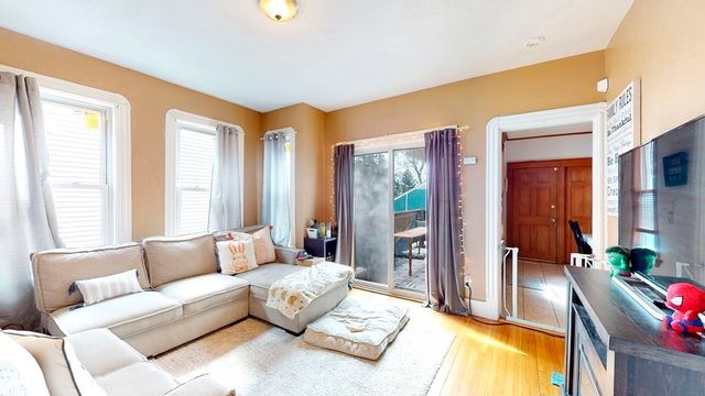 a spacious bedroom with a bed and glass window