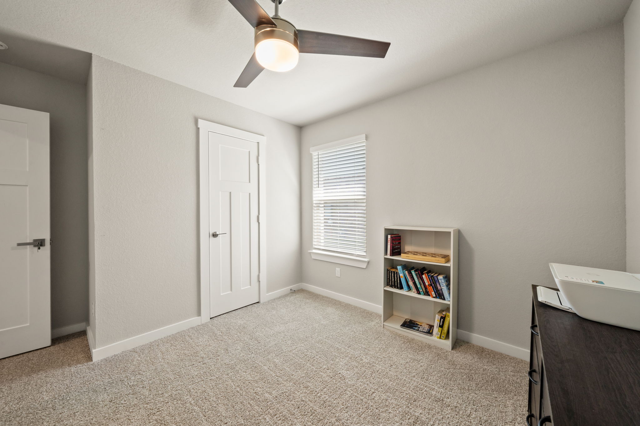1117 Tipton Street Georgetown, TX 78633 - Photo 33 of 40 Carpeted room featuring a ceiling fan with integrated lighting, a window with blinds, and white trim throughout