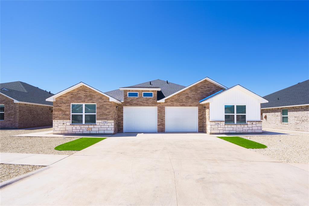 2610 Roman Lane Abilene, TX 79606 - Photo 1 of 17 a front view of a house with a garden and yard