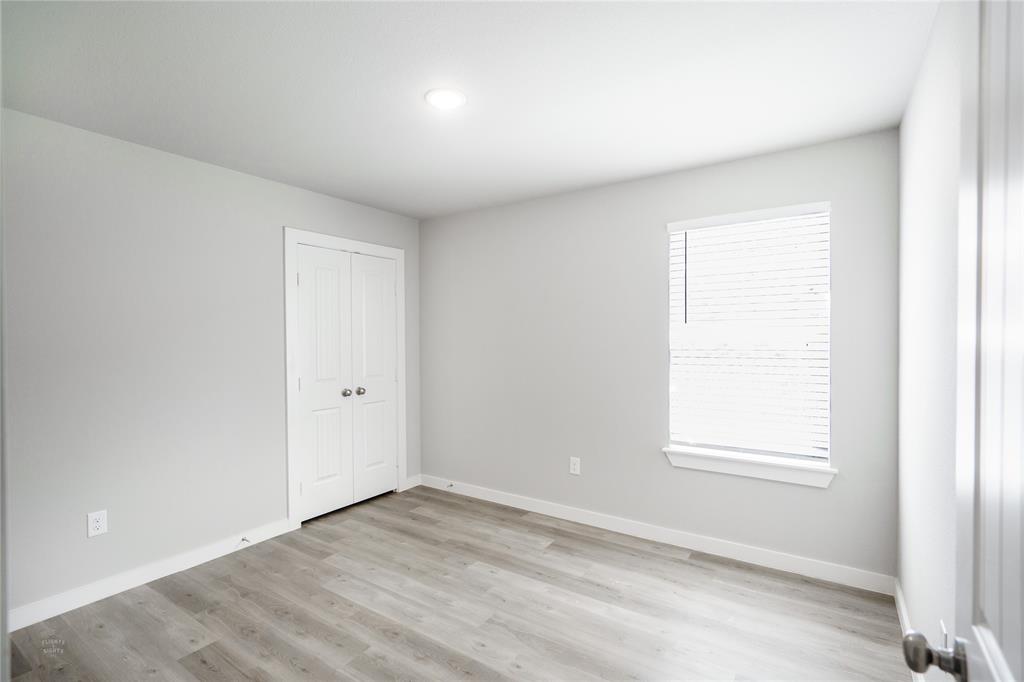 2610 Roman Lane Abilene, TX 79606 - Photo 14 of 17 an empty room with wooden floor and windows