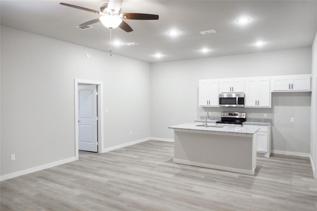 2610 Roman Lane Abilene, TX 79606 - Photo 5 of 17 a view of kitchen with stainless steel appliances granite countertop cabinets and wooden floor