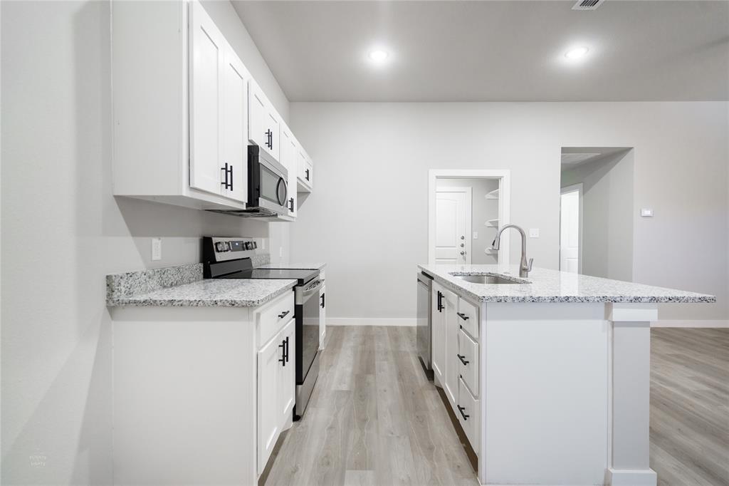 2610 Roman Lane Abilene, TX 79606 - Photo 9 of 17 a kitchen with stainless steel appliances granite countertop a stove and a sink