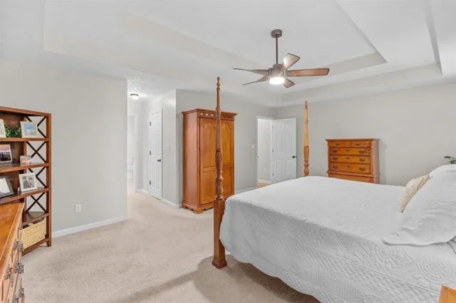 a spacious bedroom with a bed and a chandelier