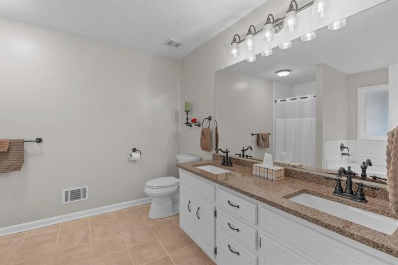 212 Wimberly Ridge McDonough, GA 30253 - Photo 14 of 44 a bathroom with a double vanity sink and a mirror