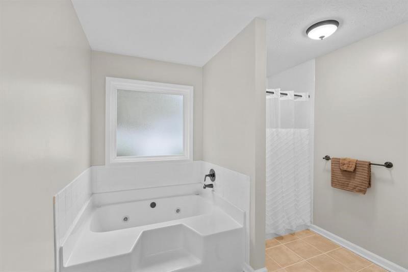 212 Wimberly Ridge McDonough, GA 30253 - Photo 15 of 44 a bathroom with a bathtub