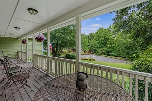 a view of balcony with wooden floor and outdoor seating