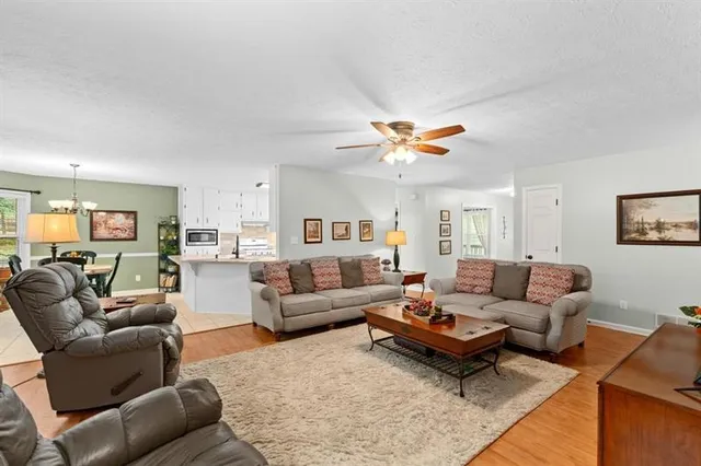 a living room with furniture and kitchen view