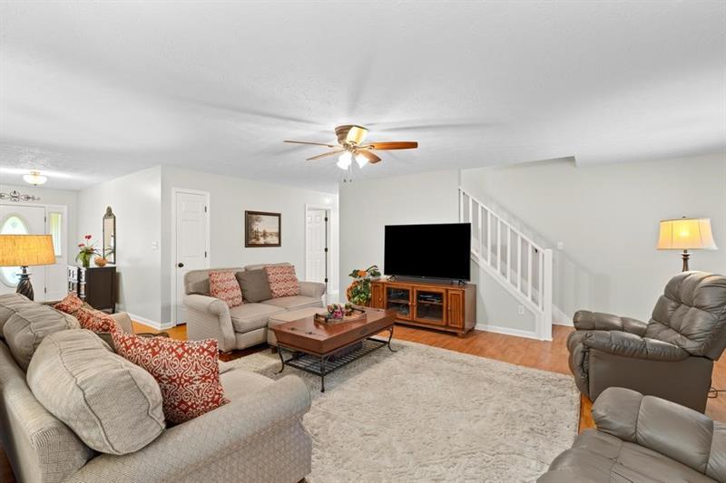 212 Wimberly Ridge McDonough, GA 30253 - Photo 6 of 44 a living room with furniture and a flat screen tv