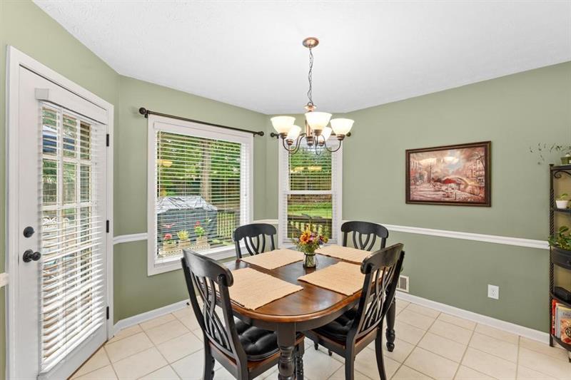 212 Wimberly Ridge McDonough, GA 30253 - Photo 7 of 44 a view of a dining room with furniture a chandelier and window